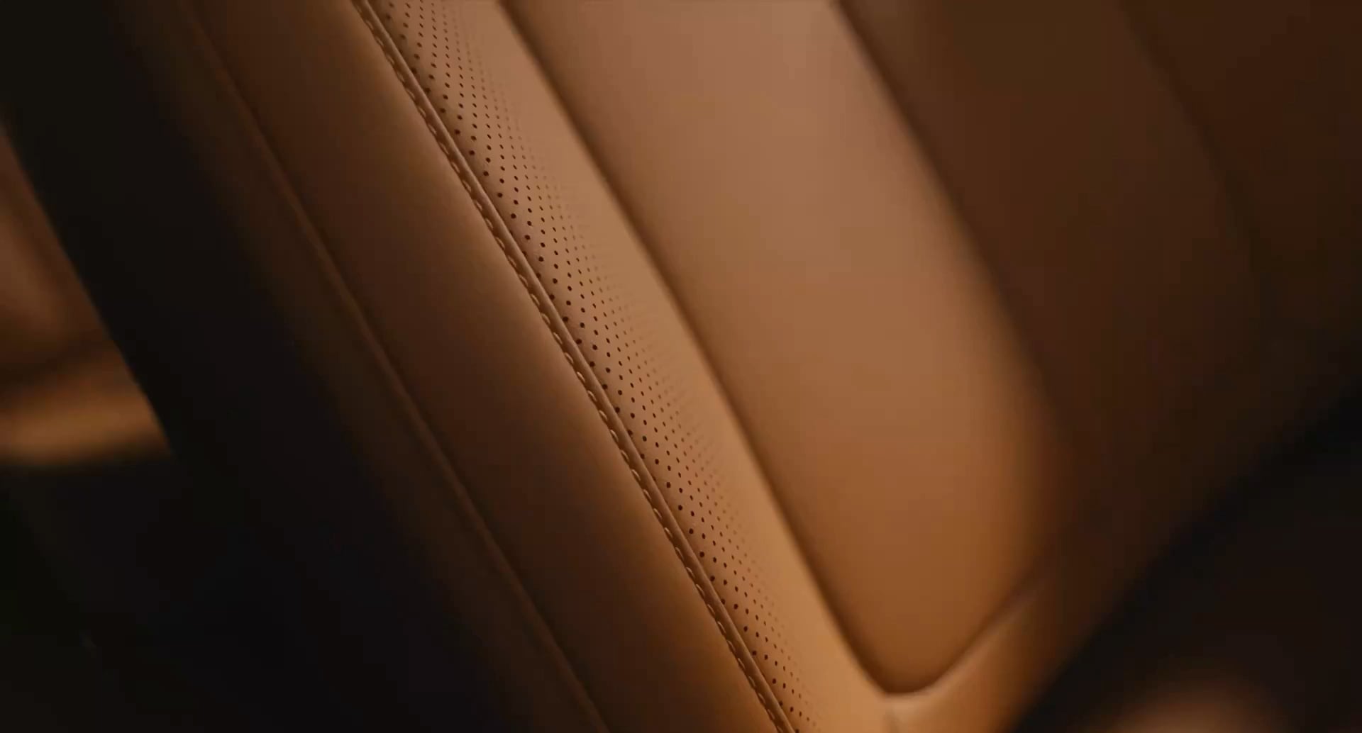 Close up of the tan leather seat in the iCAUR V27, showing the intricate stitching and high quality